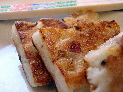 three pieces of crusty, pan-fried turnip cakes